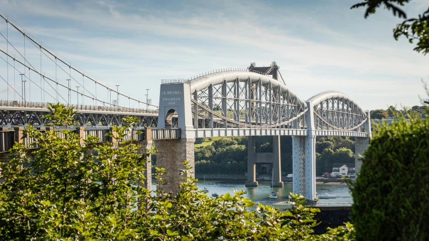 a man riding his bicycle on the underside of a bridge