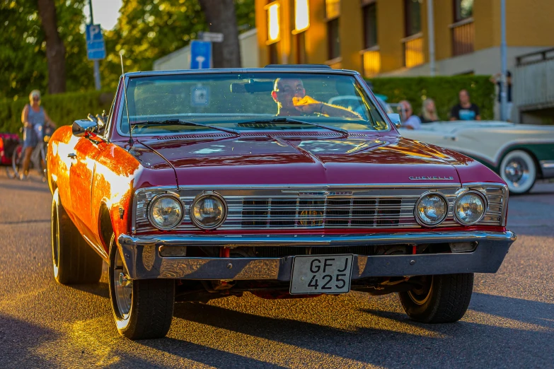 a very nice looking older model car on the street