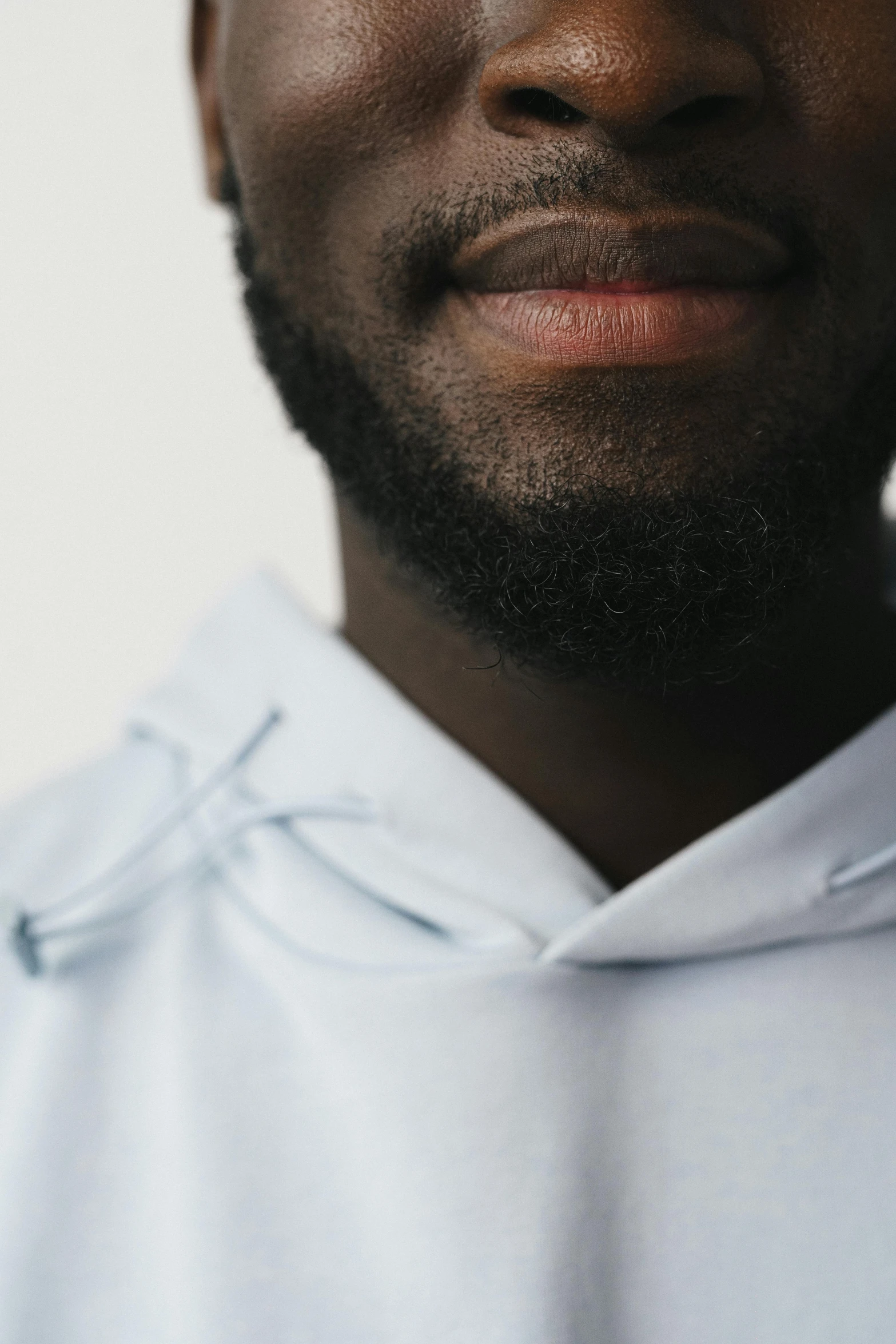 an african american man with beard and white shirt