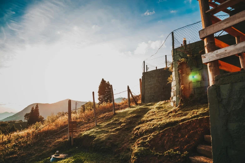 a po from the bottom of a hill, with a fence around it