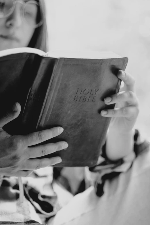 a woman reading a book while sitting down