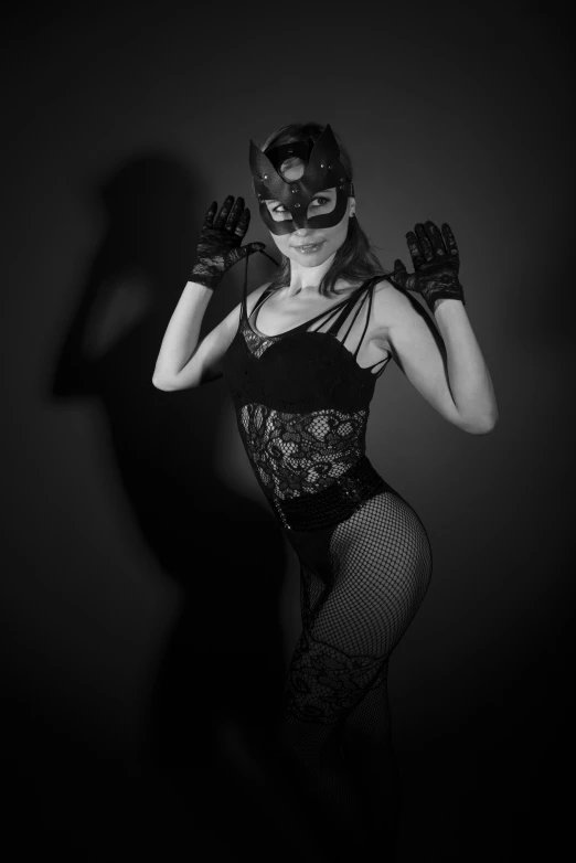 a woman in a mask and top in the dark