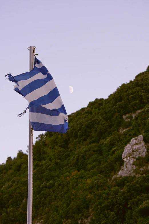 two flags and one flag are flying in the wind