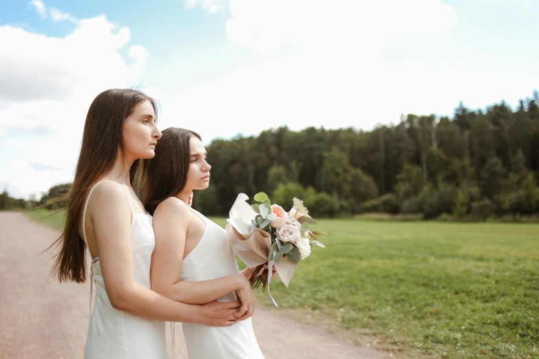 two beautiful young women standing next to each other