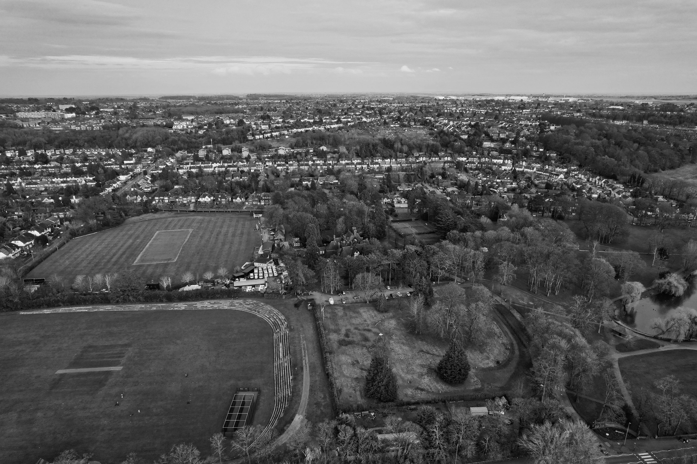 aerial view of an urban area showing trees and fields