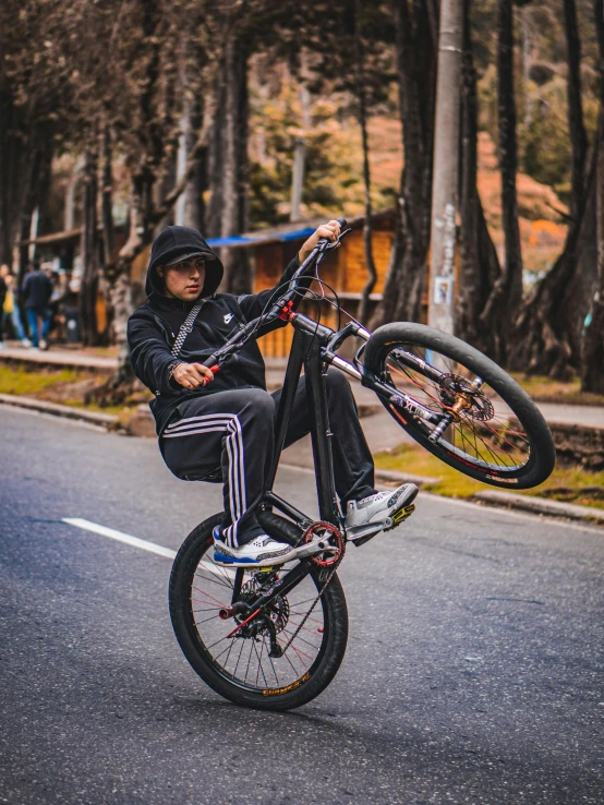 a person doing a trick on a bicycle on the street