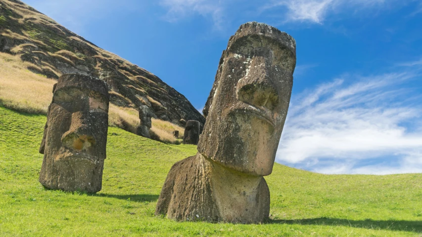 three large sculptures sitting in the middle of a field