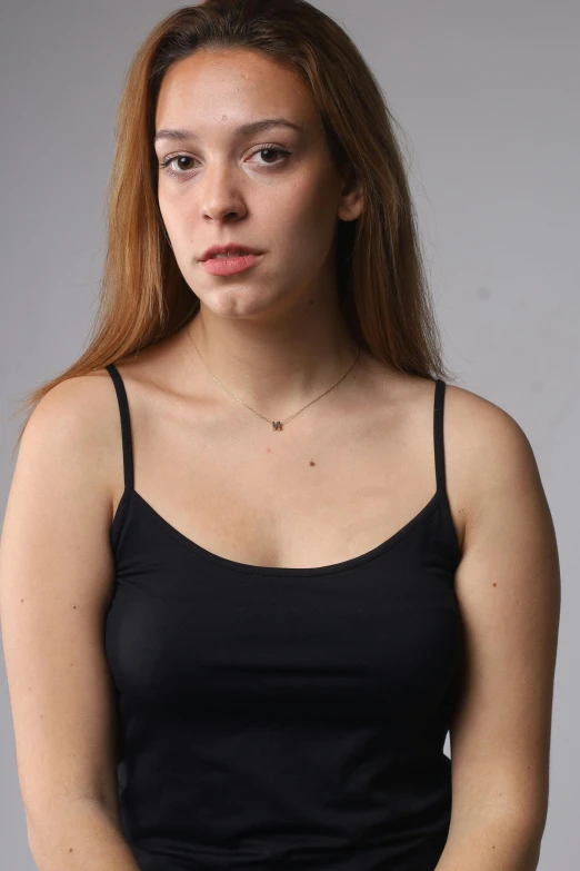 a beautiful woman wearing a black top poses for a picture