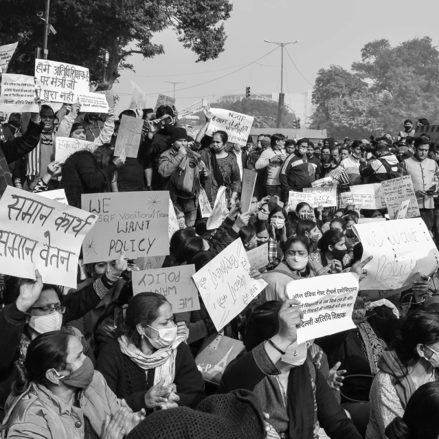 a large group of people holding signs in the air