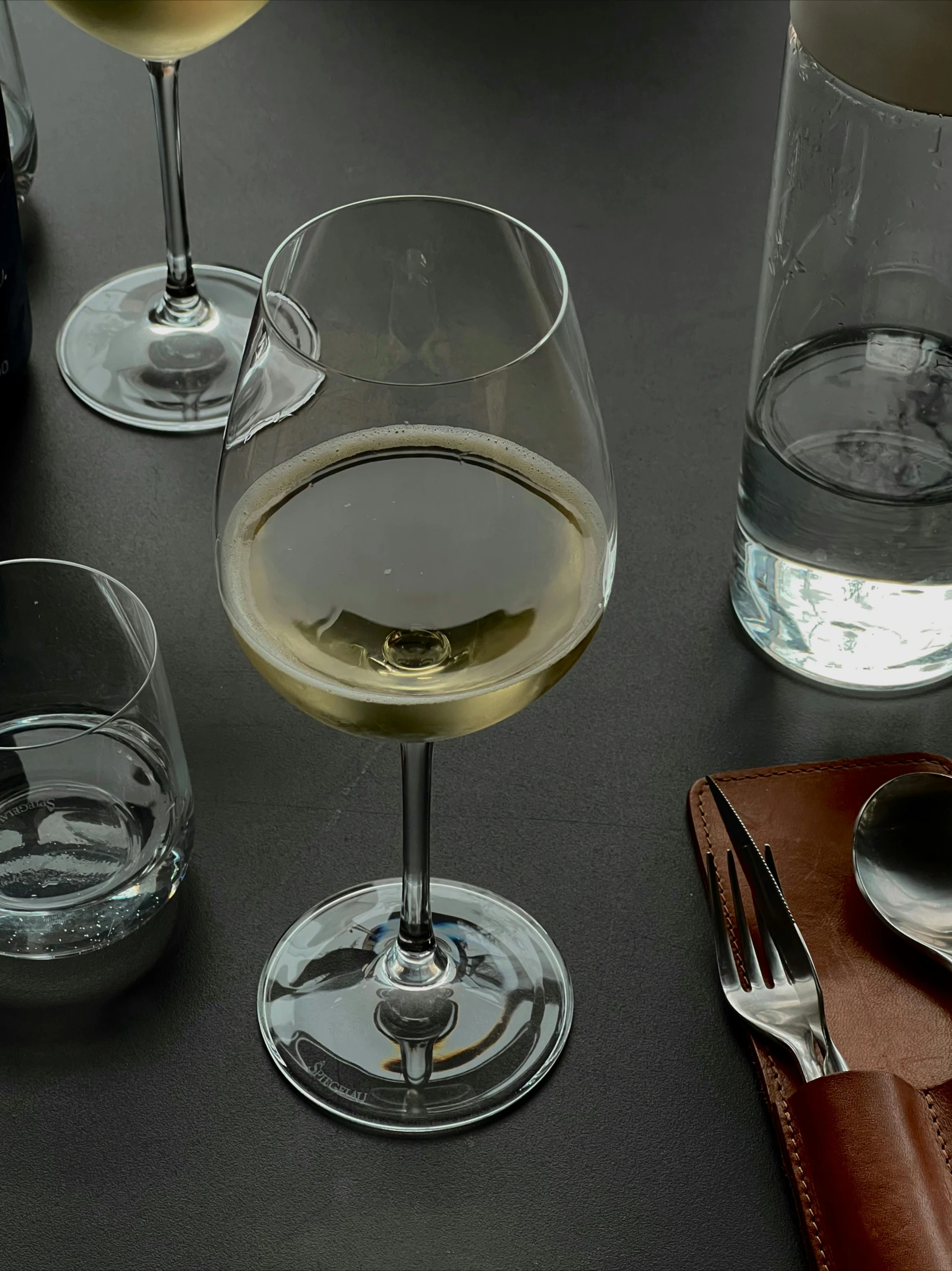 a table topped with two glasses and bottles of wine