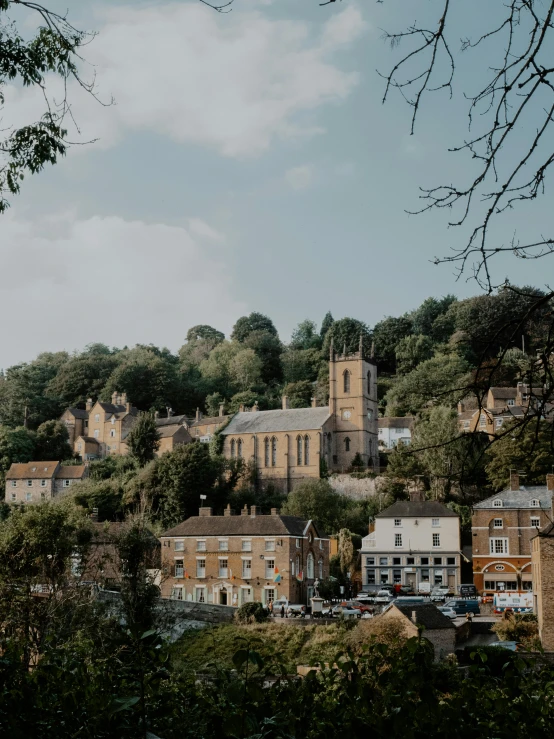 a row of stone buildings surrounded by trees