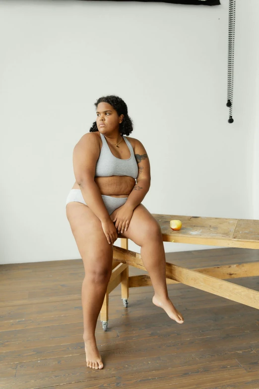 a big woman sitting on a wooden table