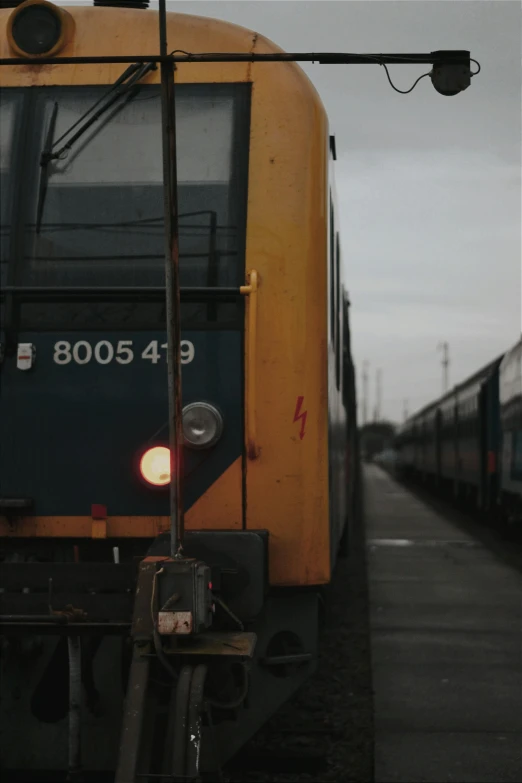 two trains are seen at a train depot