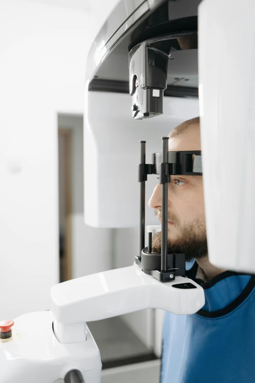 a man with glasses and a surgical device near his face