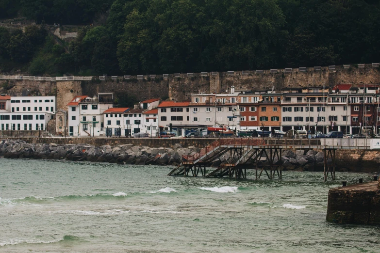 the boat is coming in the water near a pier