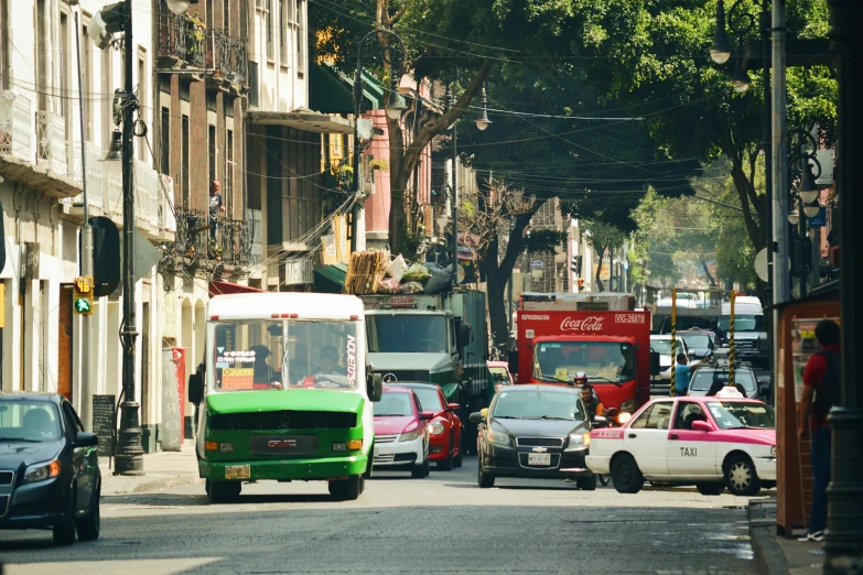 cars and a bus are driving down the street