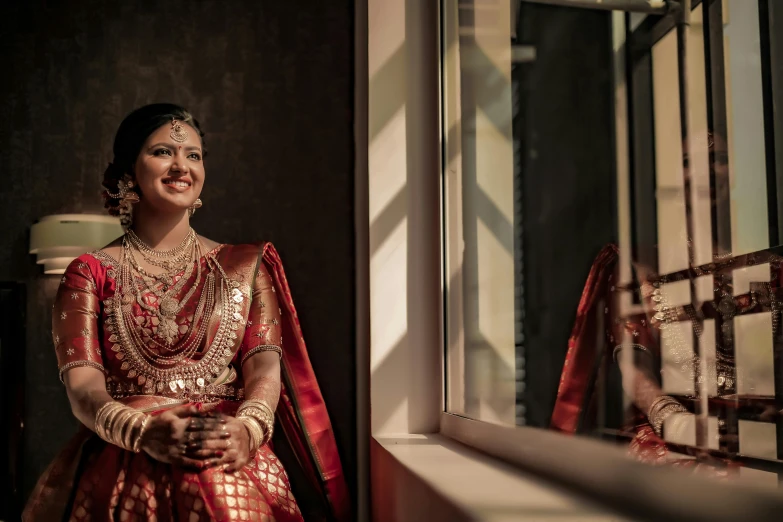 a bride sits in a window and smiles
