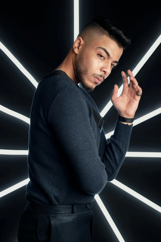 a man standing in front of a black and white tunnel with neon lines