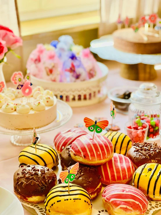 the dessert tables are adorned with colorfully decorated pastries