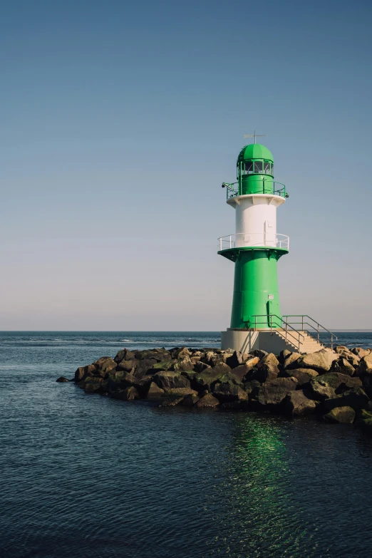 a light house sitting on top of a rock in the middle of water