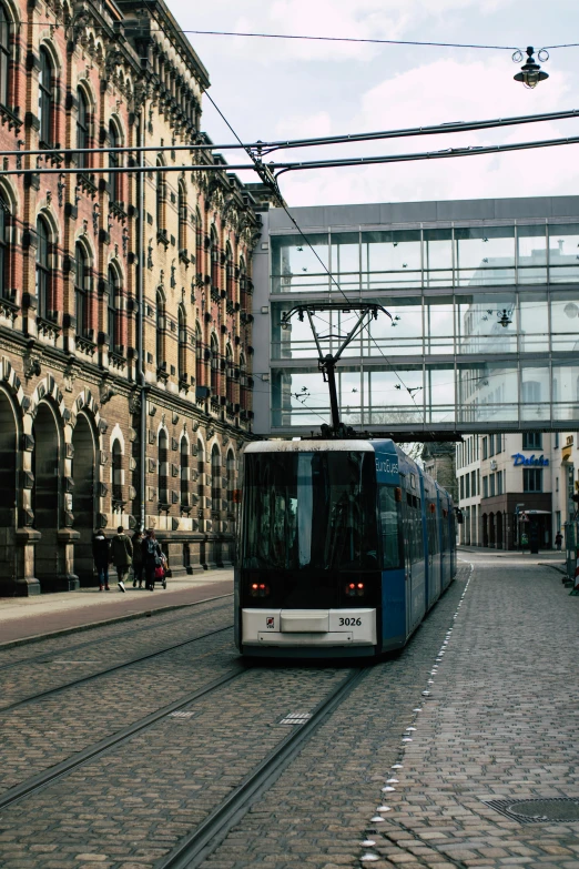 a bus traveling on a street lined with tall buildings