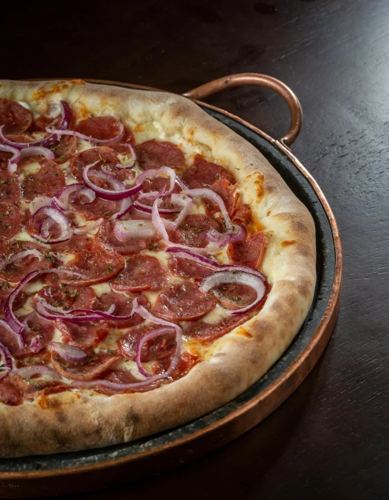 a pizza on top of a table in front of a window