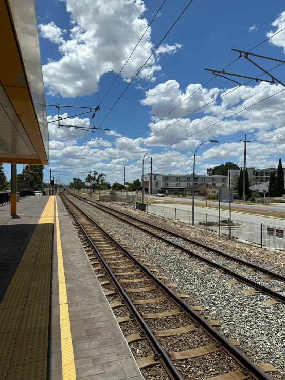 a train station platform with two sets of tracks