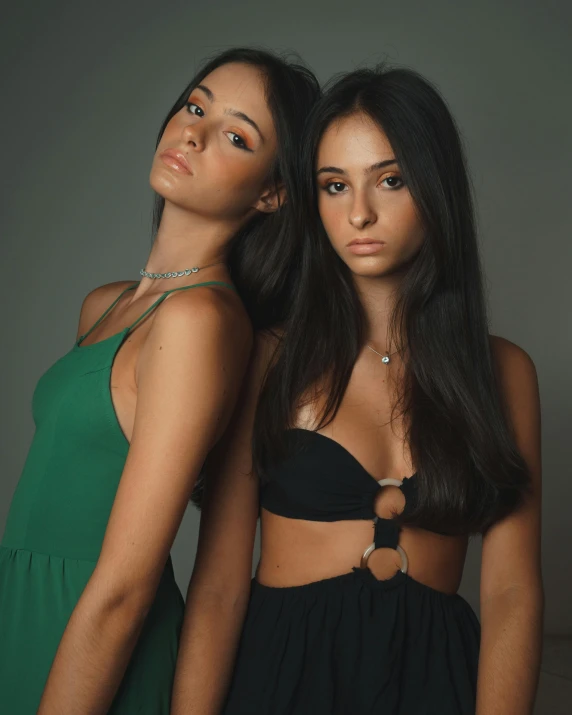 two young women wearing green and black outfits