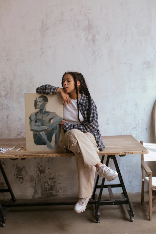 the girl is posing in front of an artwork