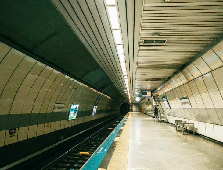 a long train station with one train in view