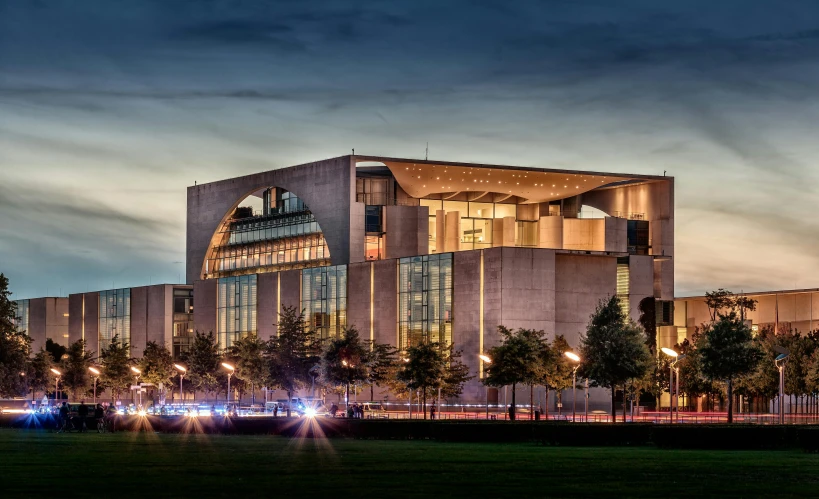 a building sits on the corner of the grassy field