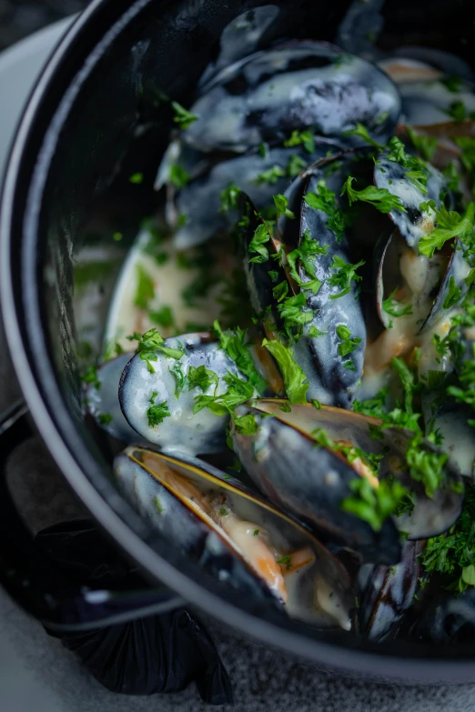 a bunch of mussels that are in a pot