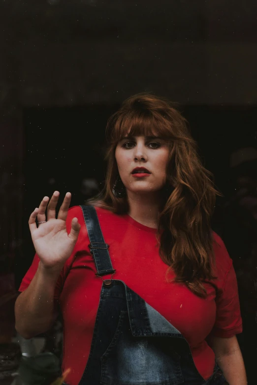 a woman posing with her fingers in the air