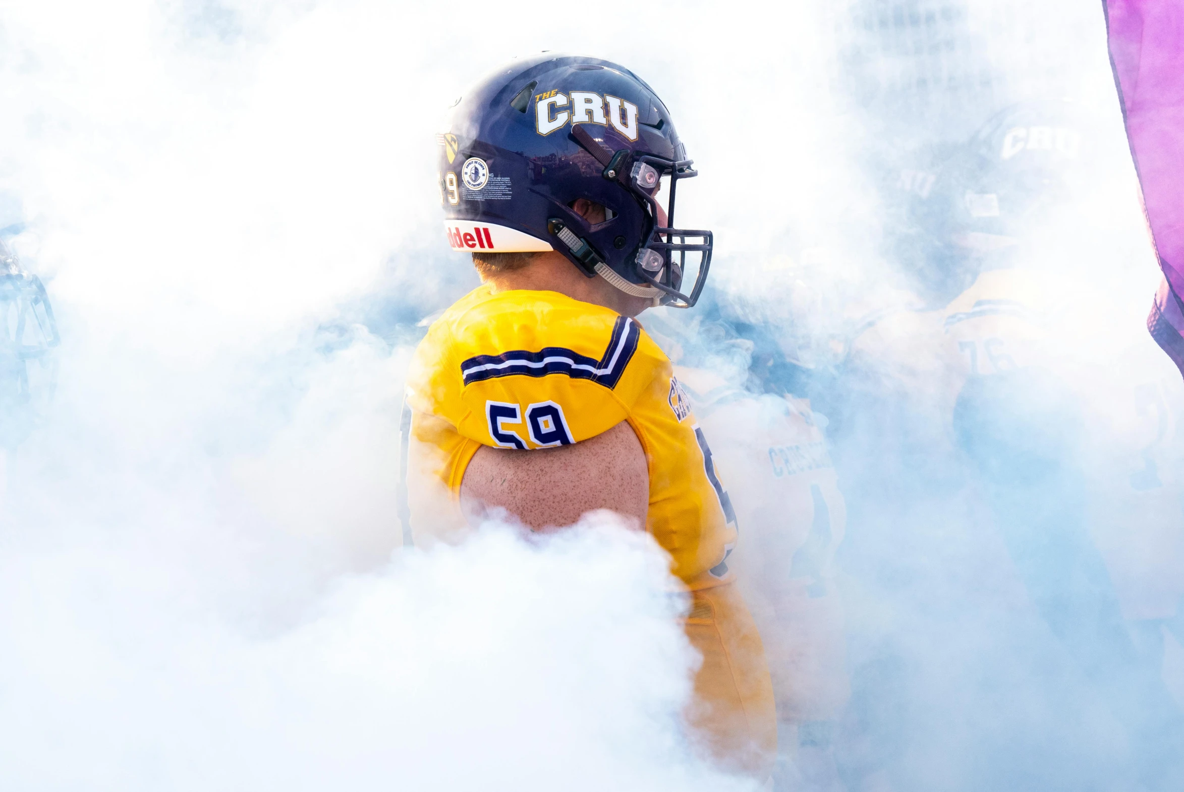 a  wearing a football uniform and helmet in smoke