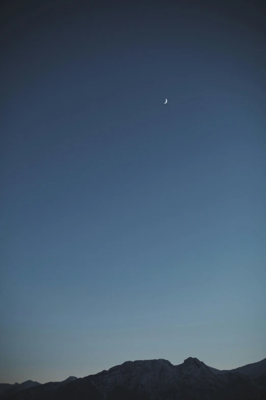 a plane flies in a dark blue sky