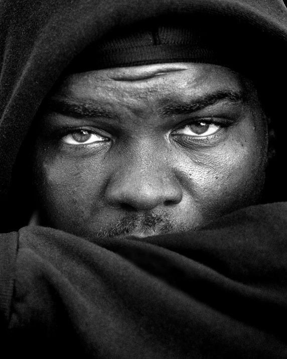 a close - up of a man wearing a hoodie