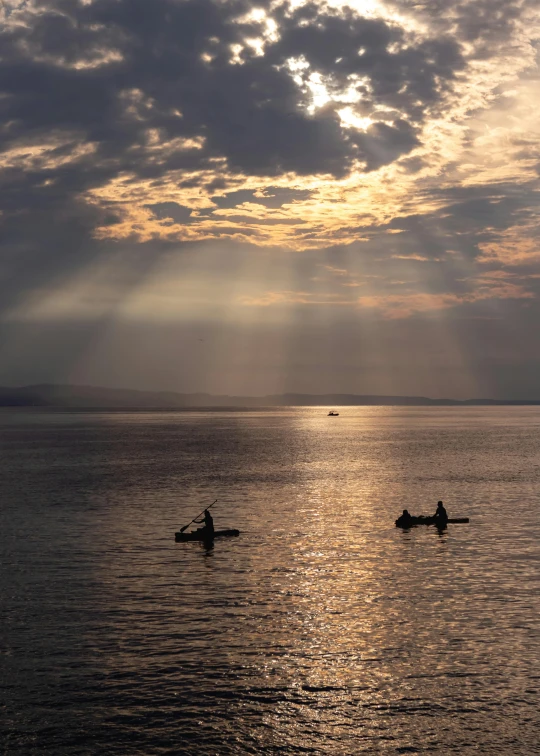 two people are riding on small boats in the water