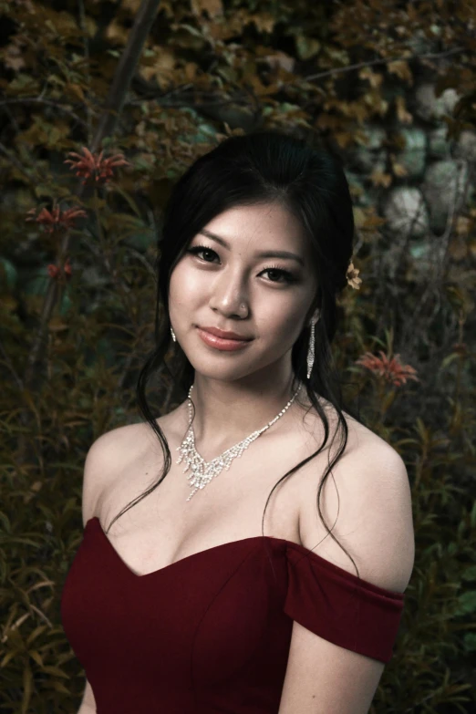 a young woman in a red dress poses for the camera