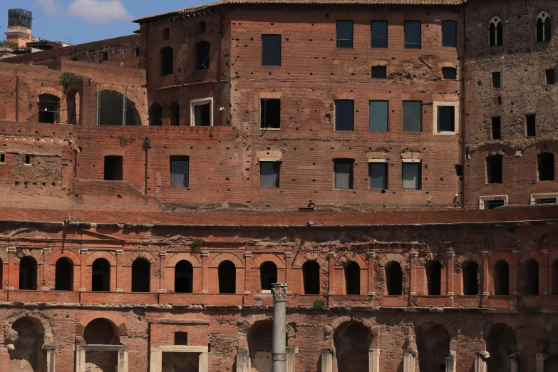 a old red brick building with windows and arches