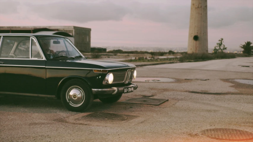 a black car is parked on the side of a road