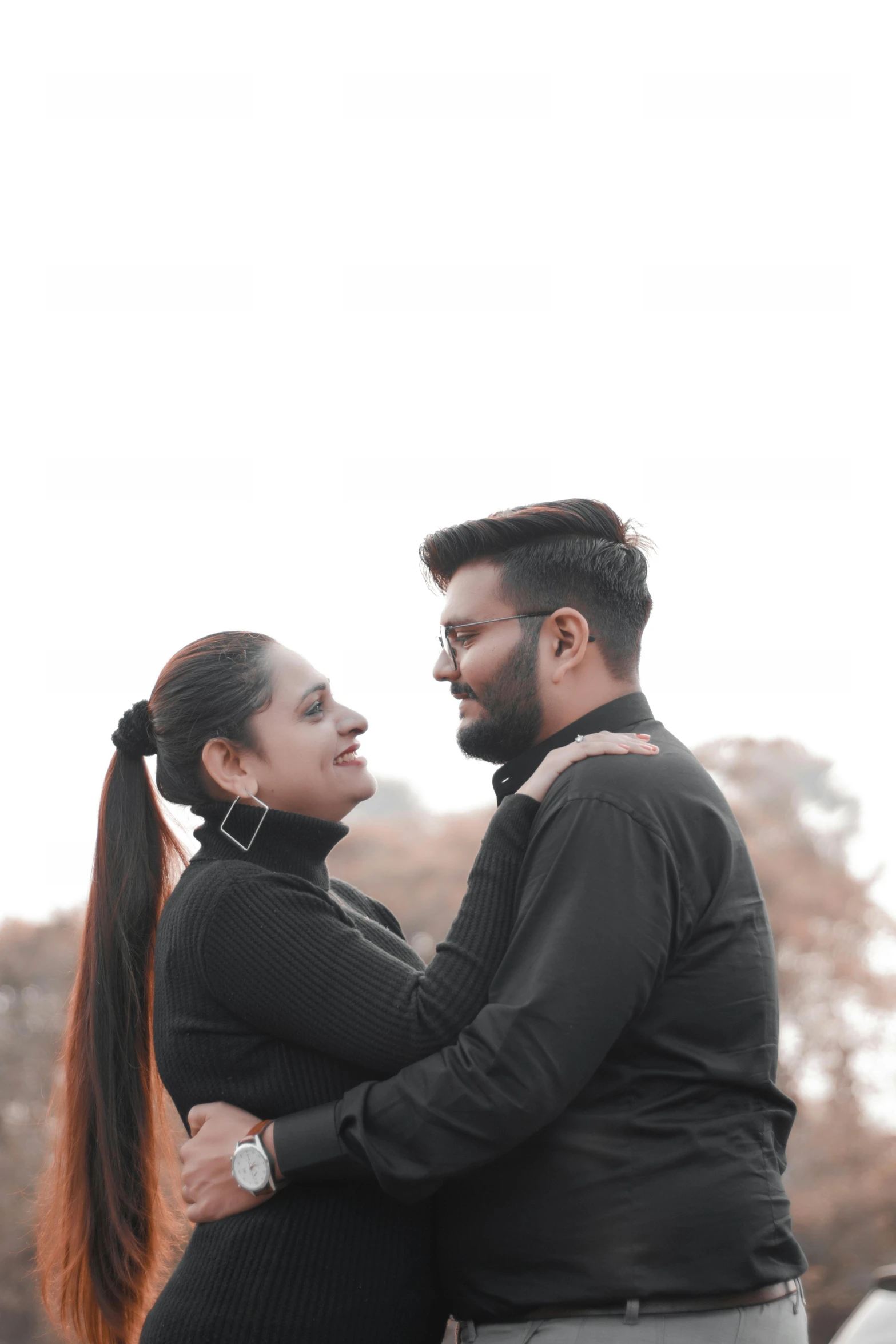 black man and woman cuddling under the sky