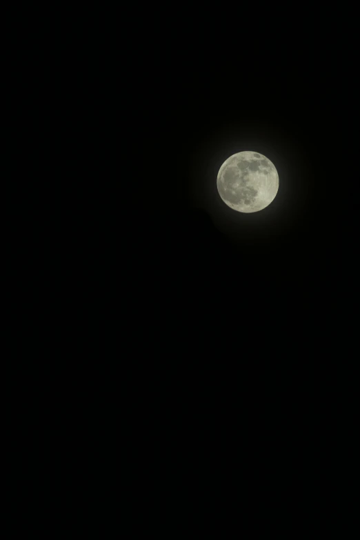 an airplane flying through the air and a large full moon