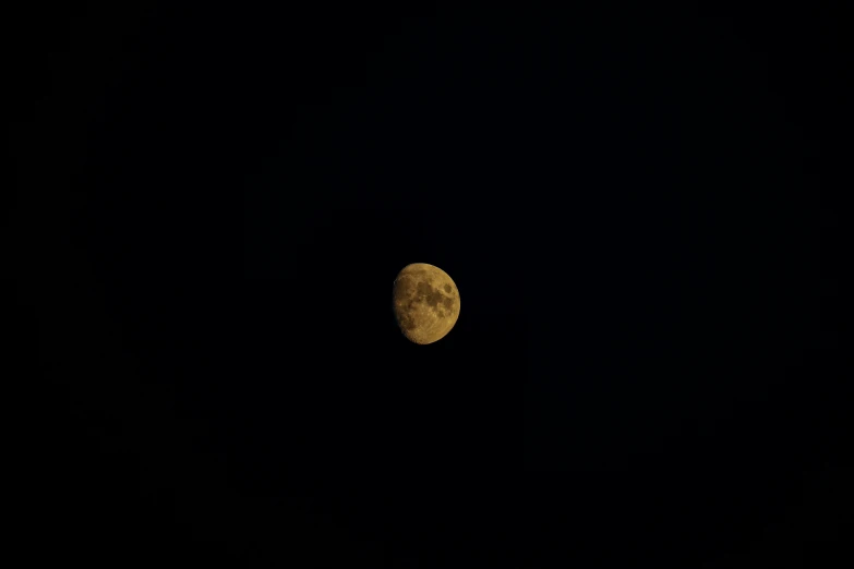 the full moon is seen in the black sky