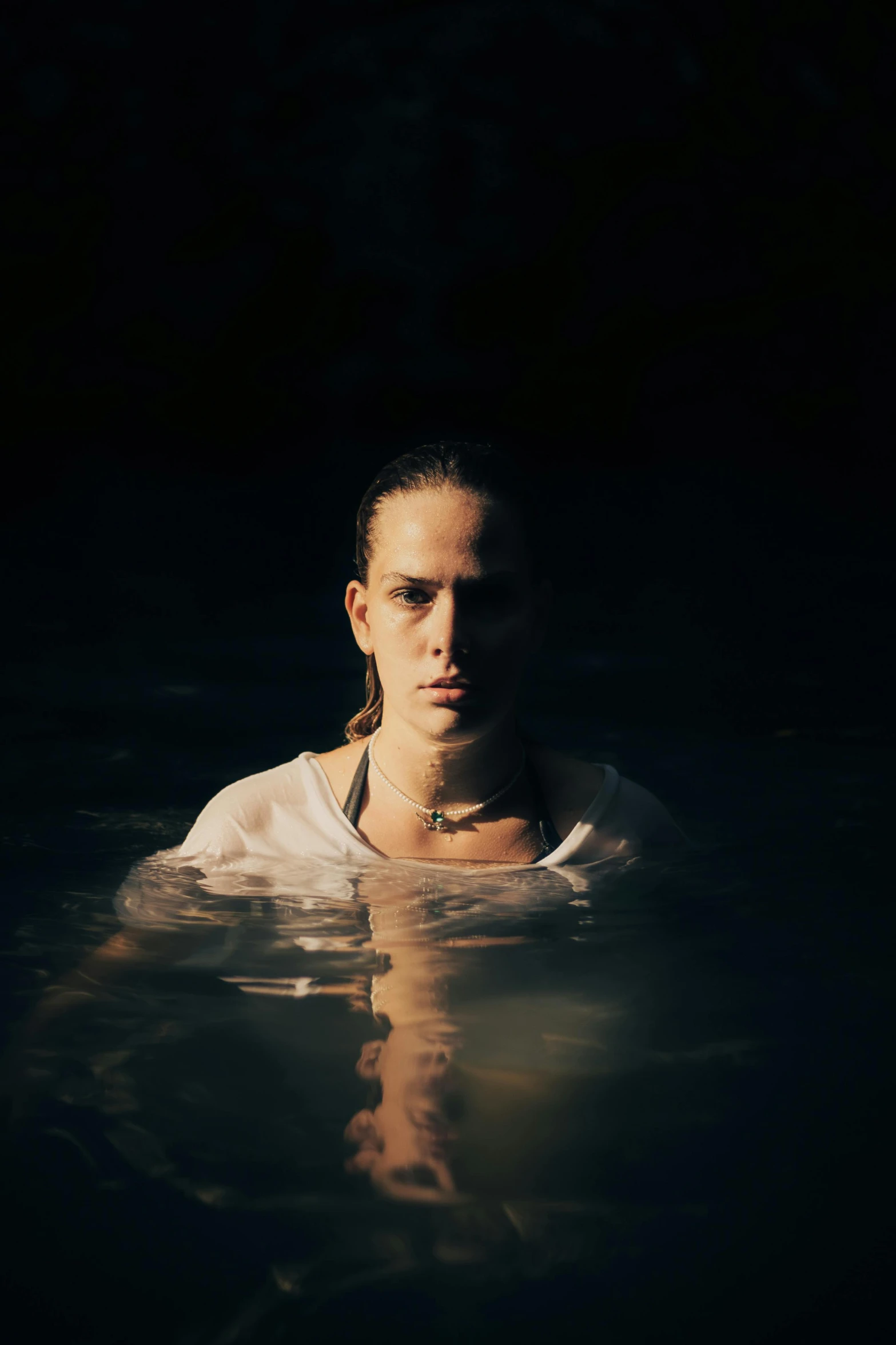 a woman swimming in the water with her head down