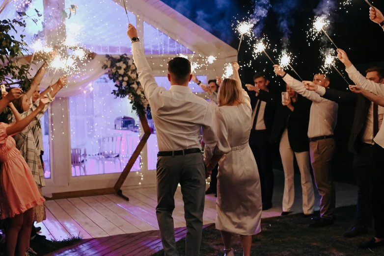 a group of people holding sparklers in their hand