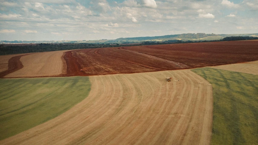 two tractors in a field with sown grass