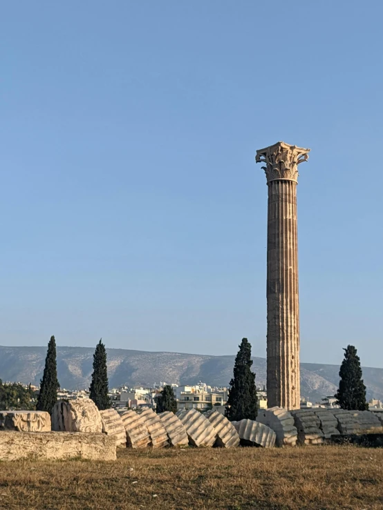 a tall pillar is in the middle of a field