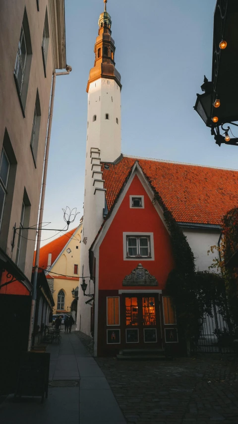 an orange house that is next to some buildings