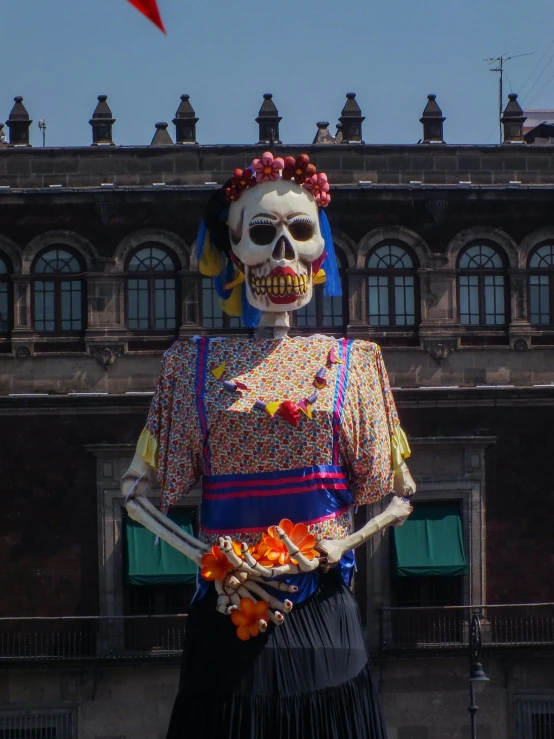 a skeleton with flowers in its hair outside