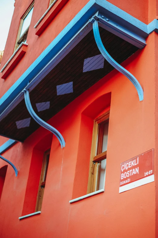 a red building with a sign that says gecceli bossian